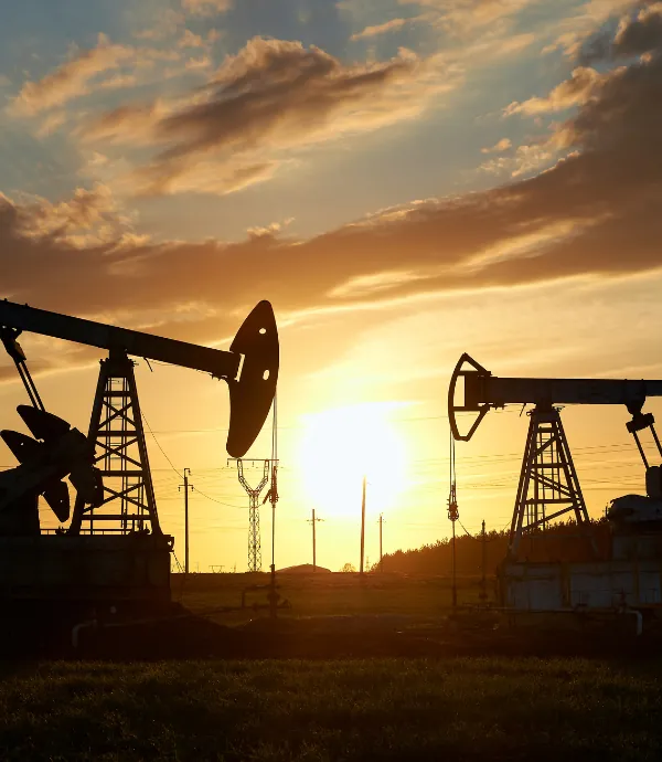 Oil and gas pump jacks at sunset
